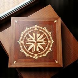 Elegant wooden game board with intricate marquetry inlay, crafted from rich walnut and maple, highlighting fine craftsmanship.